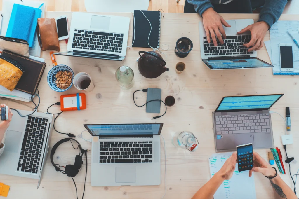 A shared workspace with laptops and notes